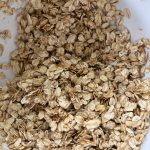 Oats with honey and oil combined in mixing bowl