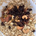 Granola with nuts and raisins in mixing bowl