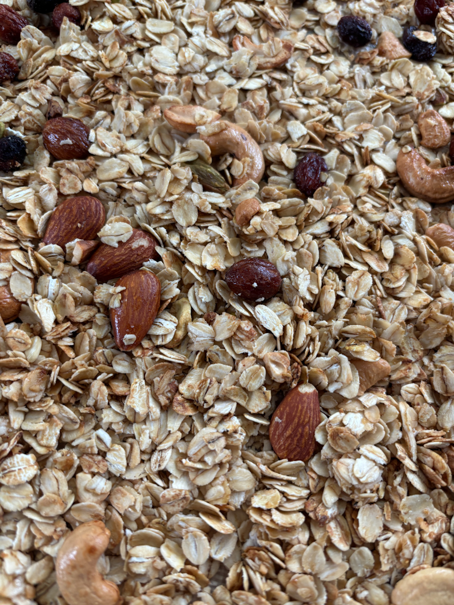 Close up of baked breakfast granola with nuts on tray