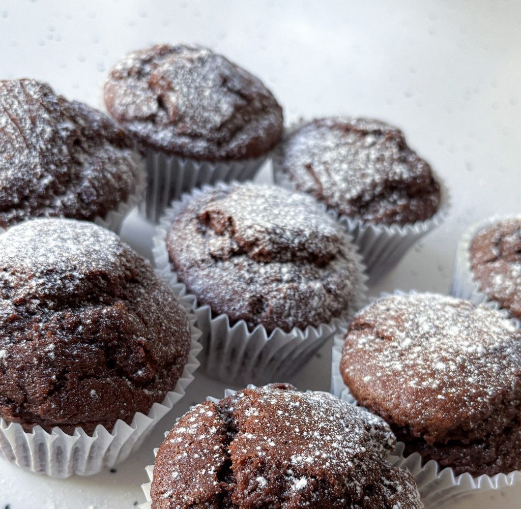 Olive Oil Chocolate Muffins dusted with powdered sugar