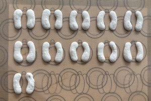 Piping pumpkin shaped macarons with a template