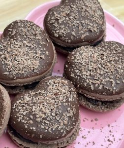 Chocolate macaron hearts covered in milk chocolate. Valentines macarons. Finished product