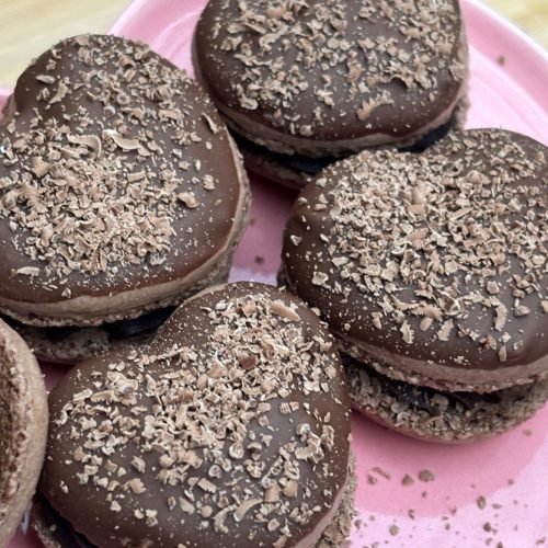 Chocolate macaron hearts covered in milk chocolate. Valentines macarons. Finished product