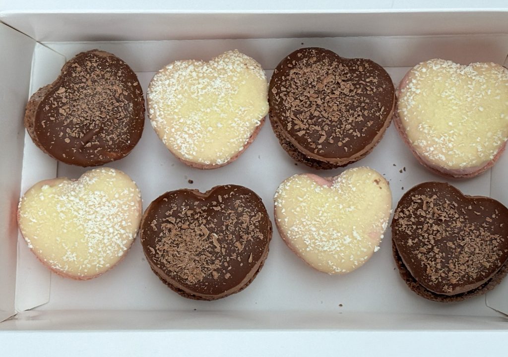 Boxed macaron hearts for valentines day white chocolate and milk chocolate topped heart macarons