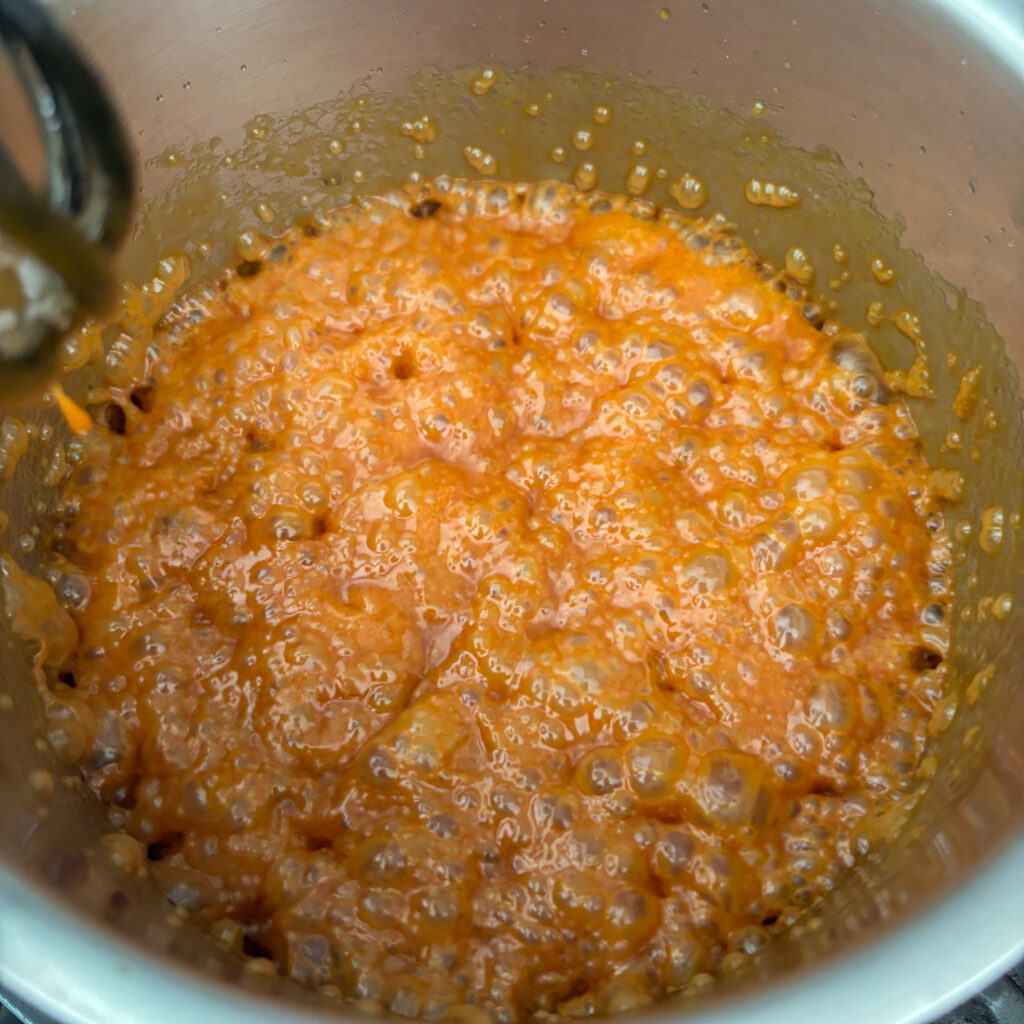 Caramel boiling in pan with cream added