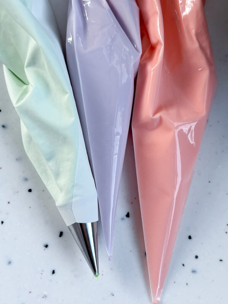 Peach, Lilac and Green Royal icing in piping bags