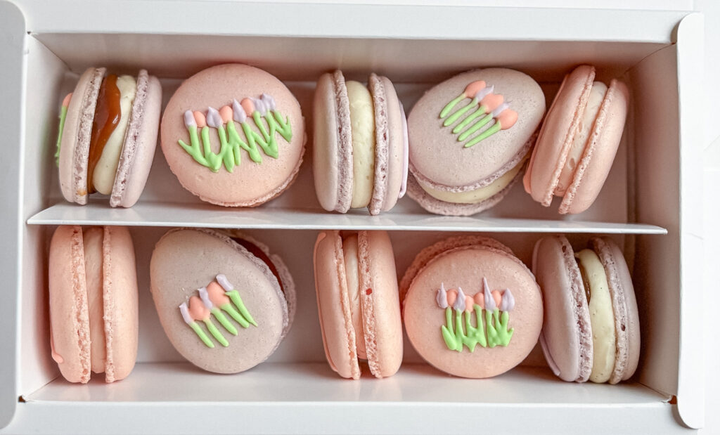 Mother's day floral macarons in bakery box. Purple and pink coloured with Royal Icing decoration - Tulip Macarons