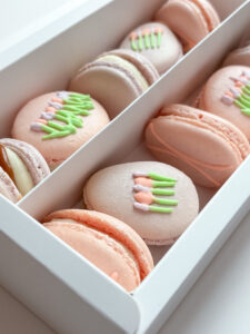 Mother's day floral macarons in bakery box. Purple and pink coloured with Royal Icing decoration - Tulip Macarons