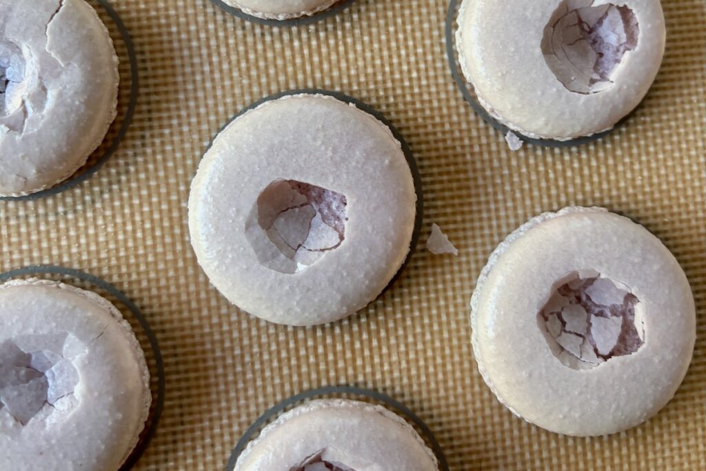 Weak macarons with finger print holes through tops caused by slightly oily almond flour