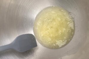 Lemon Macarons process step swiss meringue method, sugar and egg whites combined in heat proof bowl