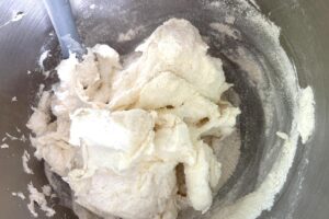 Lemon Macarons process step showing dy ingredients being incorporated with meringue