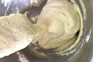 Lemon Macarons process step folding macaron batter macaronage showing batter not yet at flowing ribbon consistency