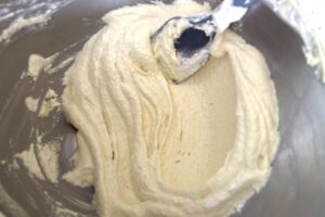 Lemon Macarons process step folding macaron batter macaronage showing batter being deflated