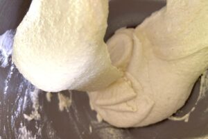 Lemon Macarons process step folding macaron batter macaronage showing batter almost at flowing ribbon consistency