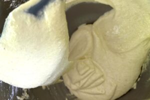 Lemon Macarons process step folding macaron batter macaronage showing batter at flowing ribbon consistency
