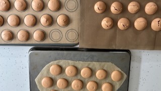 Baked macarons on teflon silicone mat and teflon showing different levels of cracking